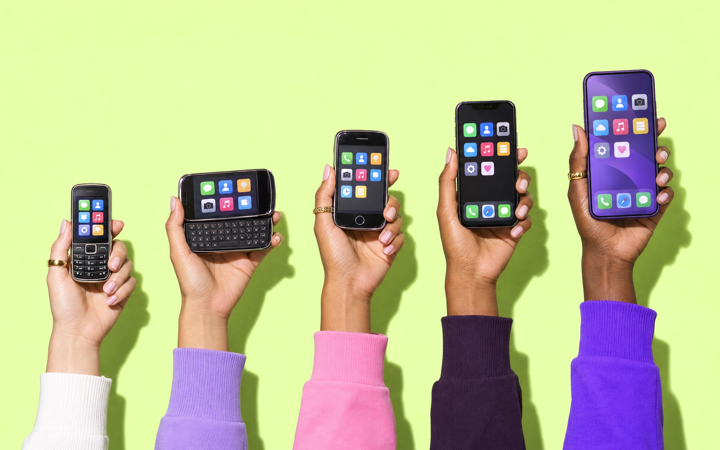 Five hands holding phones from 2008 to today, from a keypad phone to a modern smartphone.
